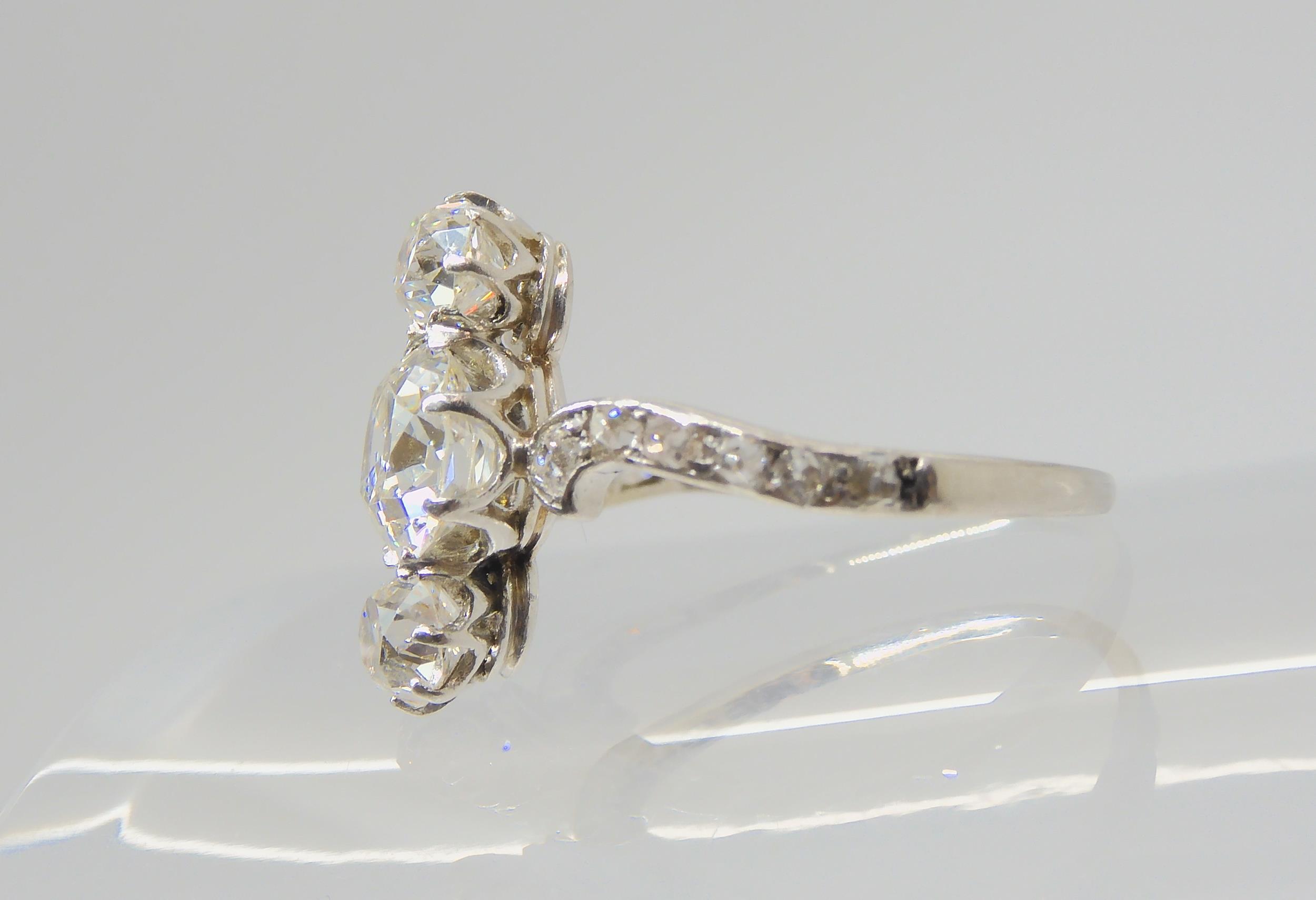 A VINTAGE THREE STONE DIAMOND RING the central old cut is estimated approximately at 0.95cts, with - Image 6 of 12