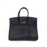 A HERMES 2010 BLACK BIRKIN 35 HANDBAG the pebbled leather exterior with dual rolled handles, top