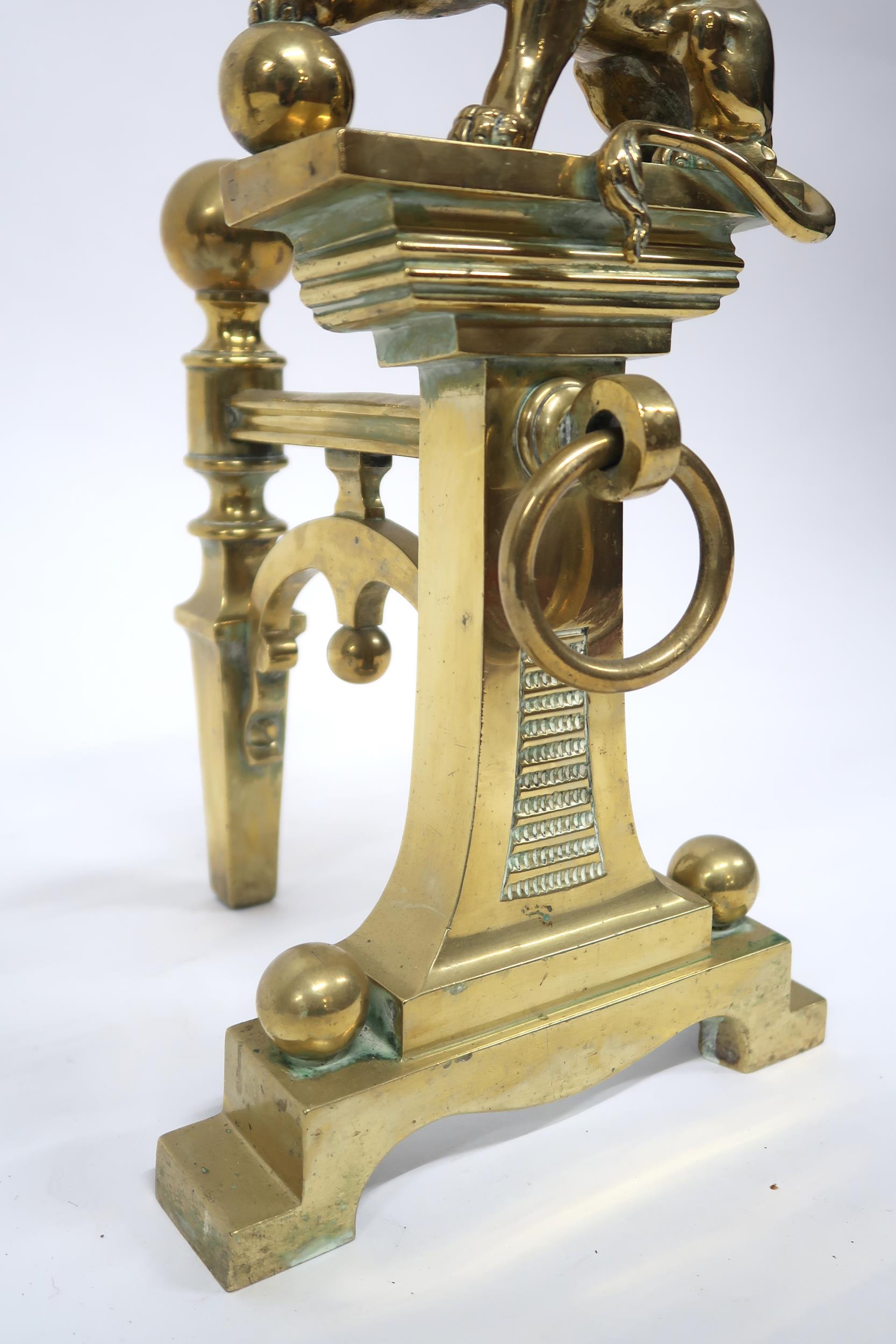 A PAIR OF EARLY 20TH CENTURY CAST BRASS FIRE DOGS mounted with figural lions, 46cm high x 23cm - Image 6 of 7