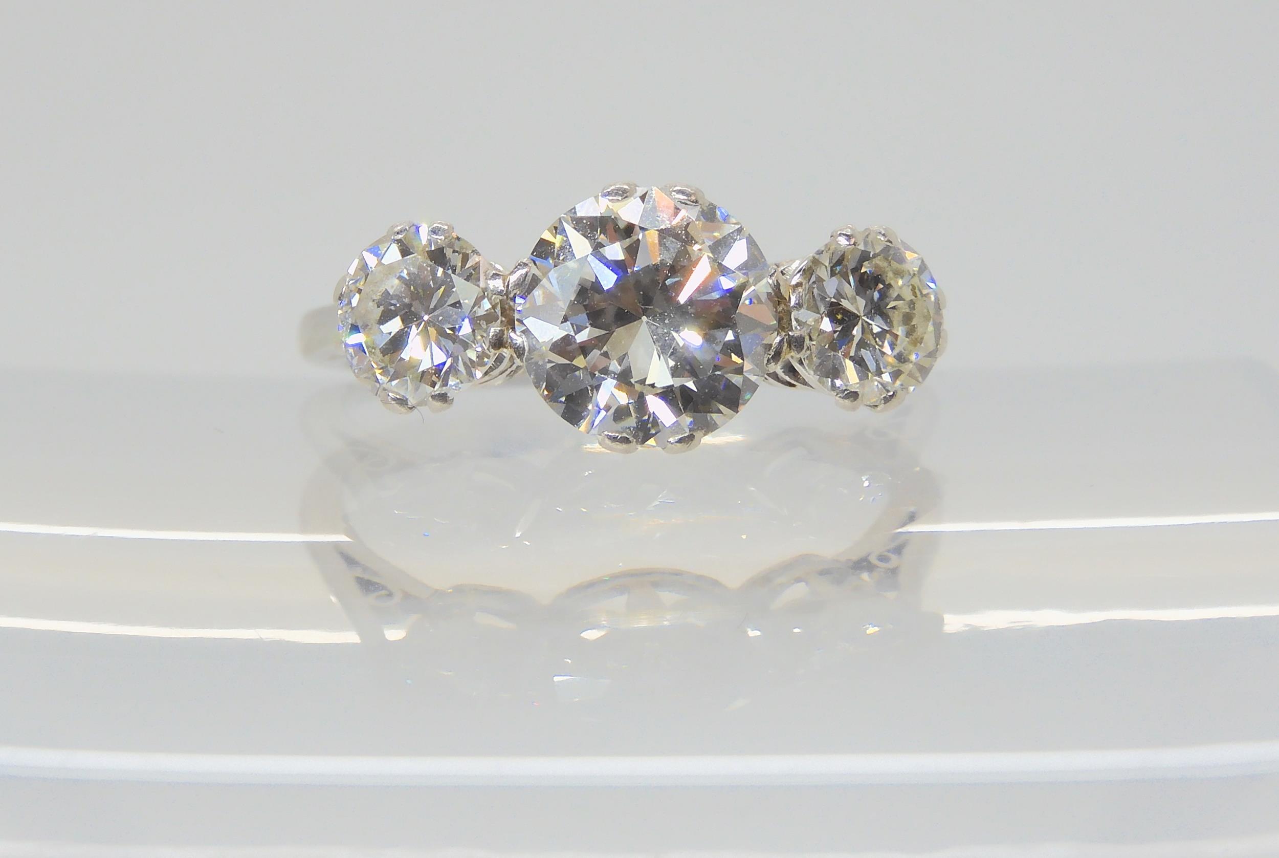 A SUBSTANTIAL DIAMOND THREE STONE RING mounted throughout in platinum, with a really pretty setting. - Image 2 of 8