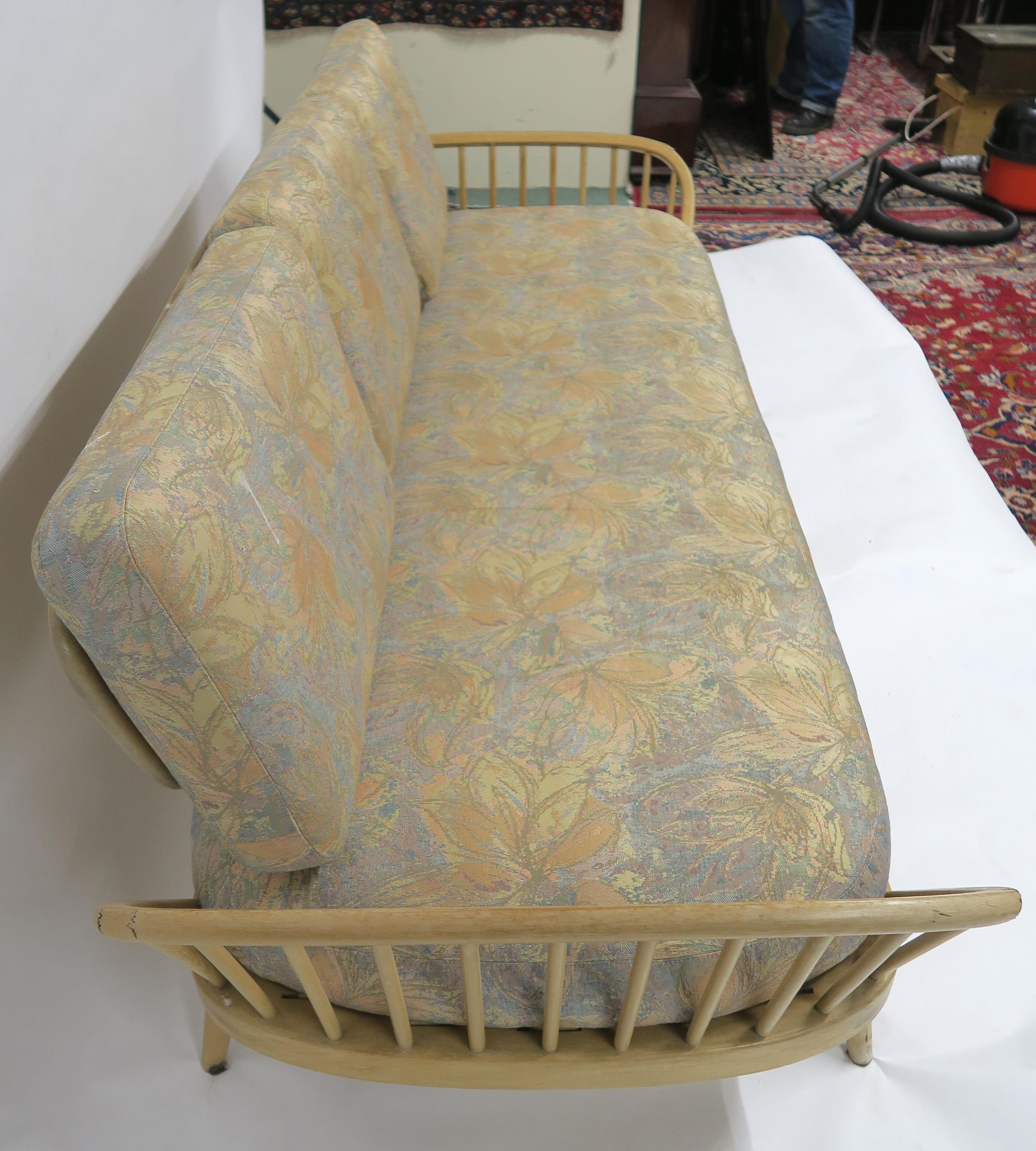 A MID 20TH CENTURY ELM AND BEECH FRAMED ERCOL DAY BED with floral upholstered cushions, 77cm high - Image 8 of 11