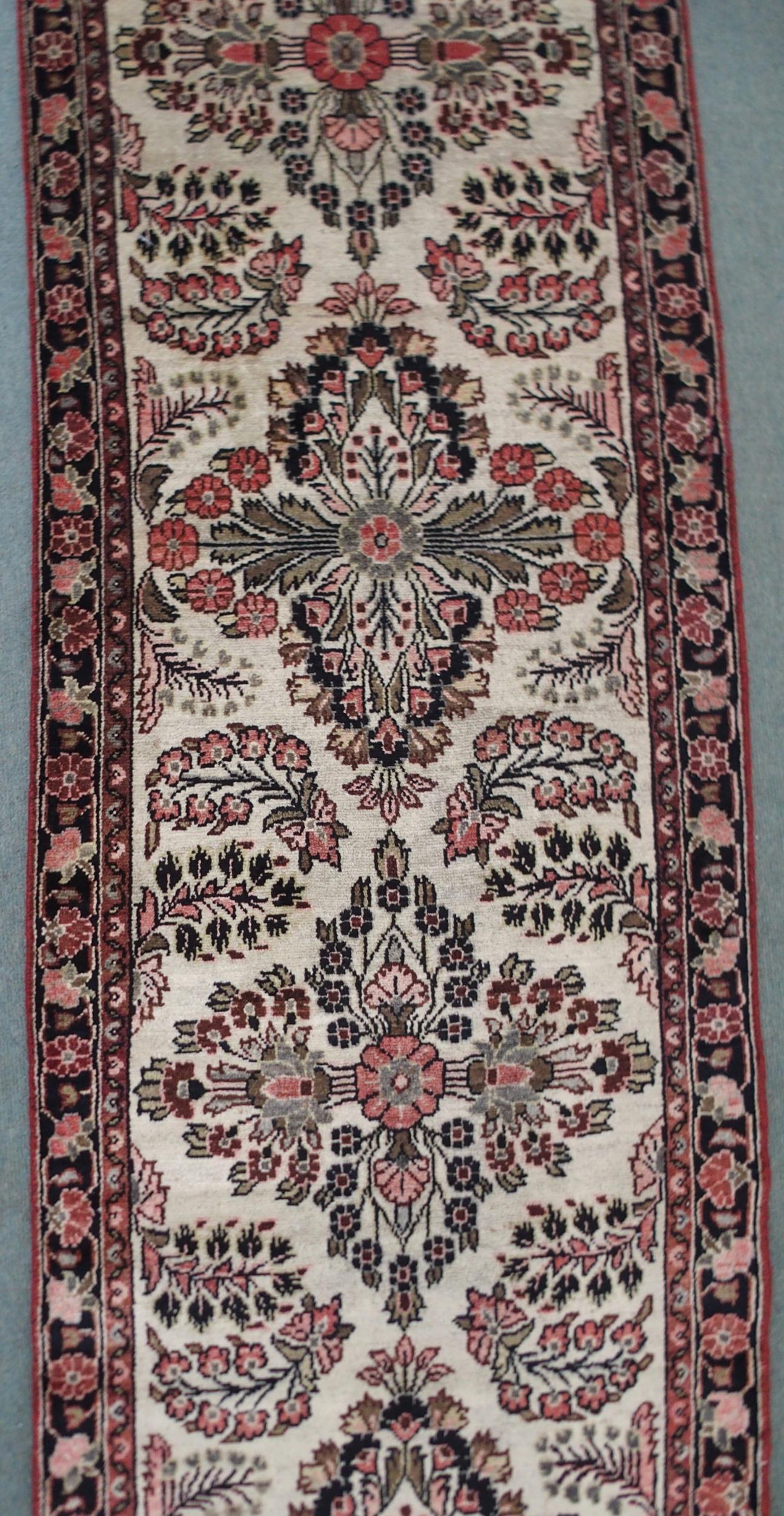 A CREAM GROUND HAMADAN RUNNER with seven floral medallions and dark blue floral border, 459cm long x - Image 3 of 6