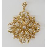 AN EDWARDIAN PENDANT BROOCH the 15ct gold pendant is set with split pearls and a central old cut