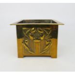 A GLASGOW SCHOOL ARTS AND CRAFTS BRASS PLANTER with relief decoration of flowers and stylised