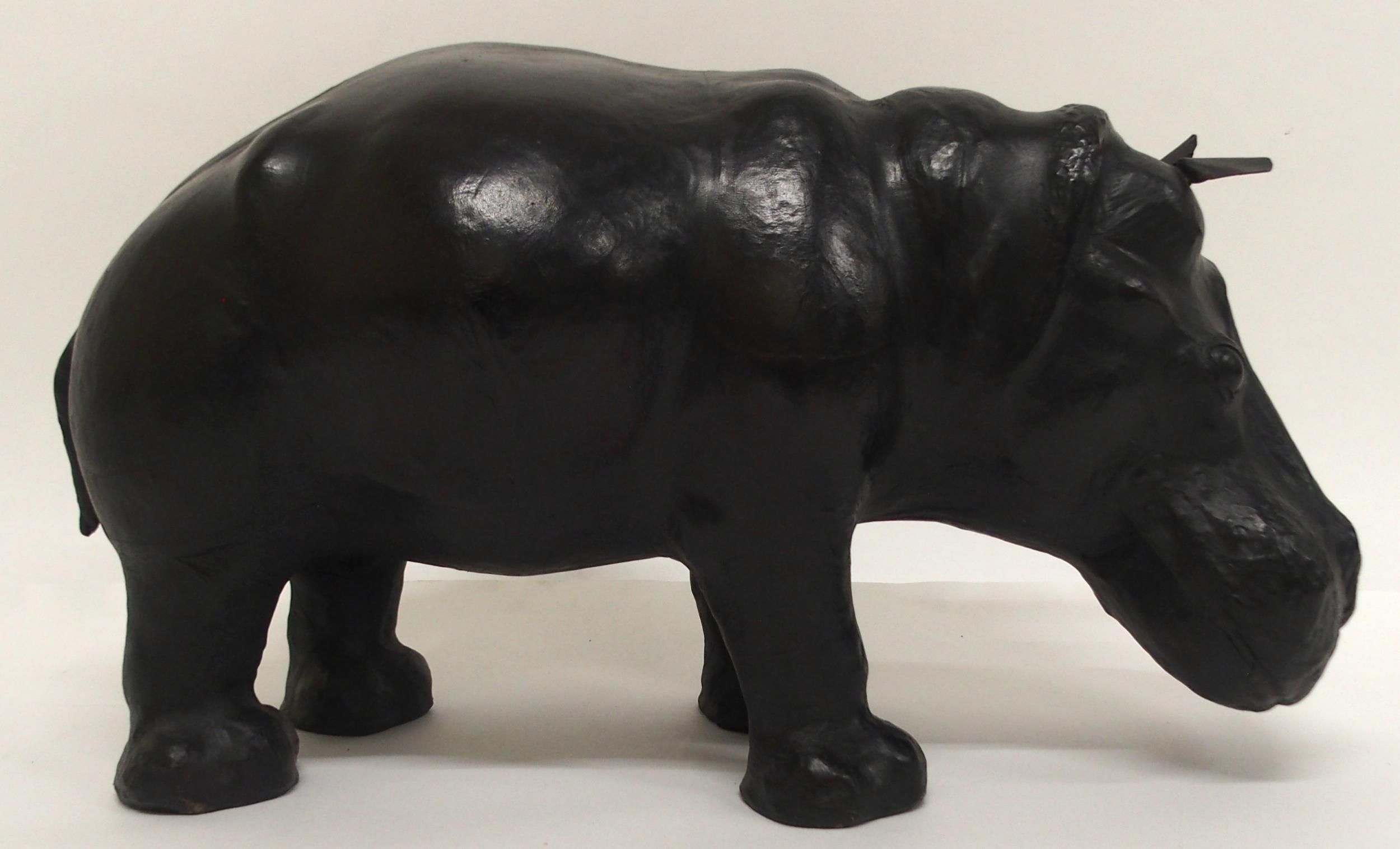 AN EARLY 20TH CENTURY LIBERTY OF LONDON STYLE LEATHER HIPPOPOTAMUS FOOTSTOOL with glass eyes, 32cm