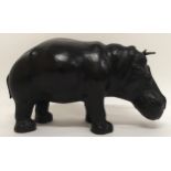 AN EARLY 20TH CENTURY LIBERTY OF LONDON STYLE LEATHER HIPPOPOTAMUS FOOTSTOOL with glass eyes, 32cm