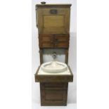 A 19/20TH CENTURY TEAK SHIPS CABIN WASH STAND with three asymmetrical cabinet doors over fall