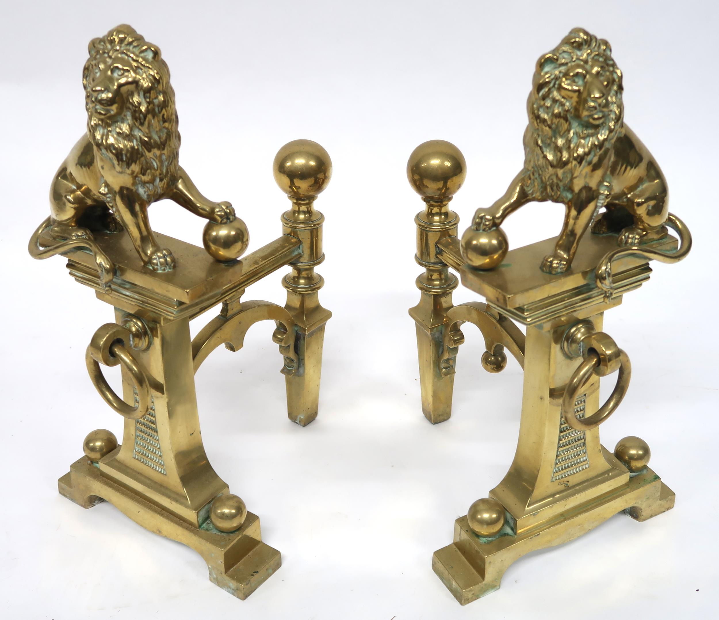 A PAIR OF EARLY 20TH CENTURY CAST BRASS FIRE DOGS mounted with figural lions, 46cm high x 23cm - Image 2 of 7