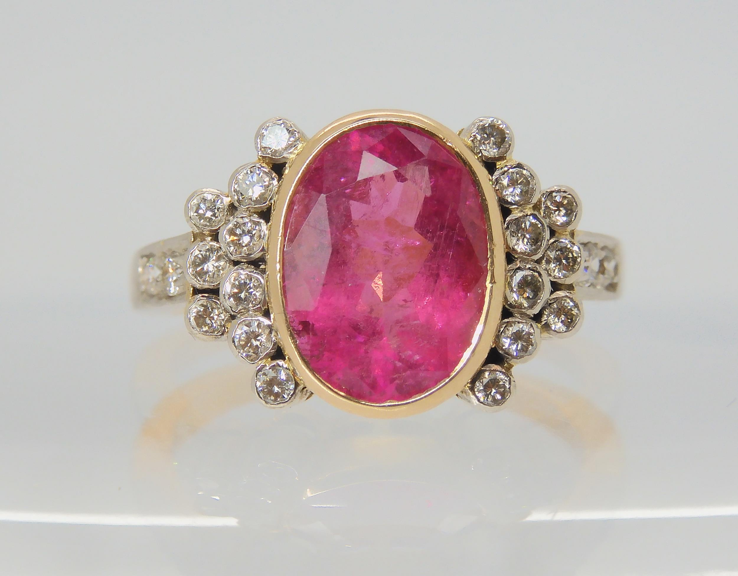 A PINK TOURMALINE AND DIAMOND RING the mount is stamped 750 for 18ct, and set with a 10.8mm x 8.