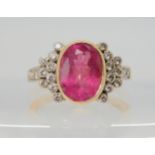 A PINK TOURMALINE AND DIAMOND RING the mount is stamped 750 for 18ct, and set with a 10.8mm x 8.