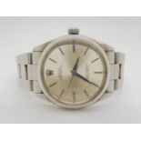 A ROLEX OYSTER PERPETUAL with stainless steel case and strap (78350). Silvered dial with silver