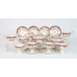 A ROCKINGHAM STYLE TEASET of moulded rococo design, the white ground with gilt vine and grape