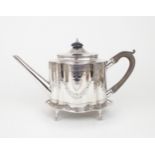 A GEORGE III SCOTTISH SILVER TEAPOT AND STAND of shaped oval form, the body bright-engraved with