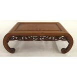 A 20TH CENTURY CHINESE HARDWOOD LOW TABLE with central birds eye maple panel, carved floral fretwork