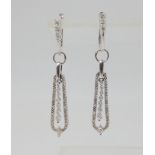 A PAIR OF DIAMOND DROP EARRINGS mounted in 14k white gold, and set with estimated approx 0.60cts