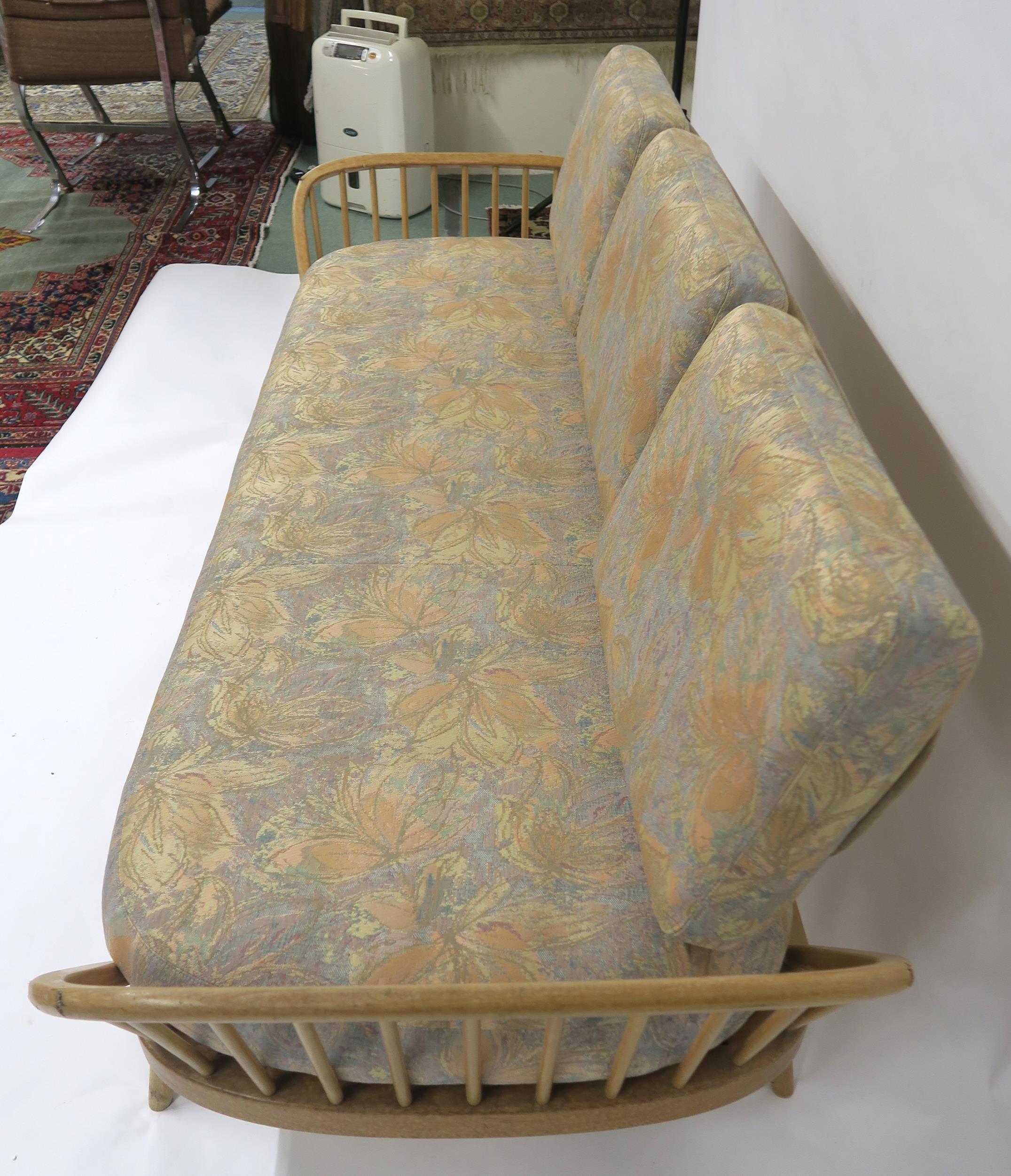 A MID 20TH CENTURY ELM AND BEECH FRAMED ERCOL DAY BED with floral upholstered cushions, 77cm high - Image 7 of 11