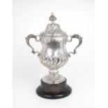 A GEORGE III SILVER TWIN HANDLED CUP AND COVER the baluster form body embossed with spiral fluting