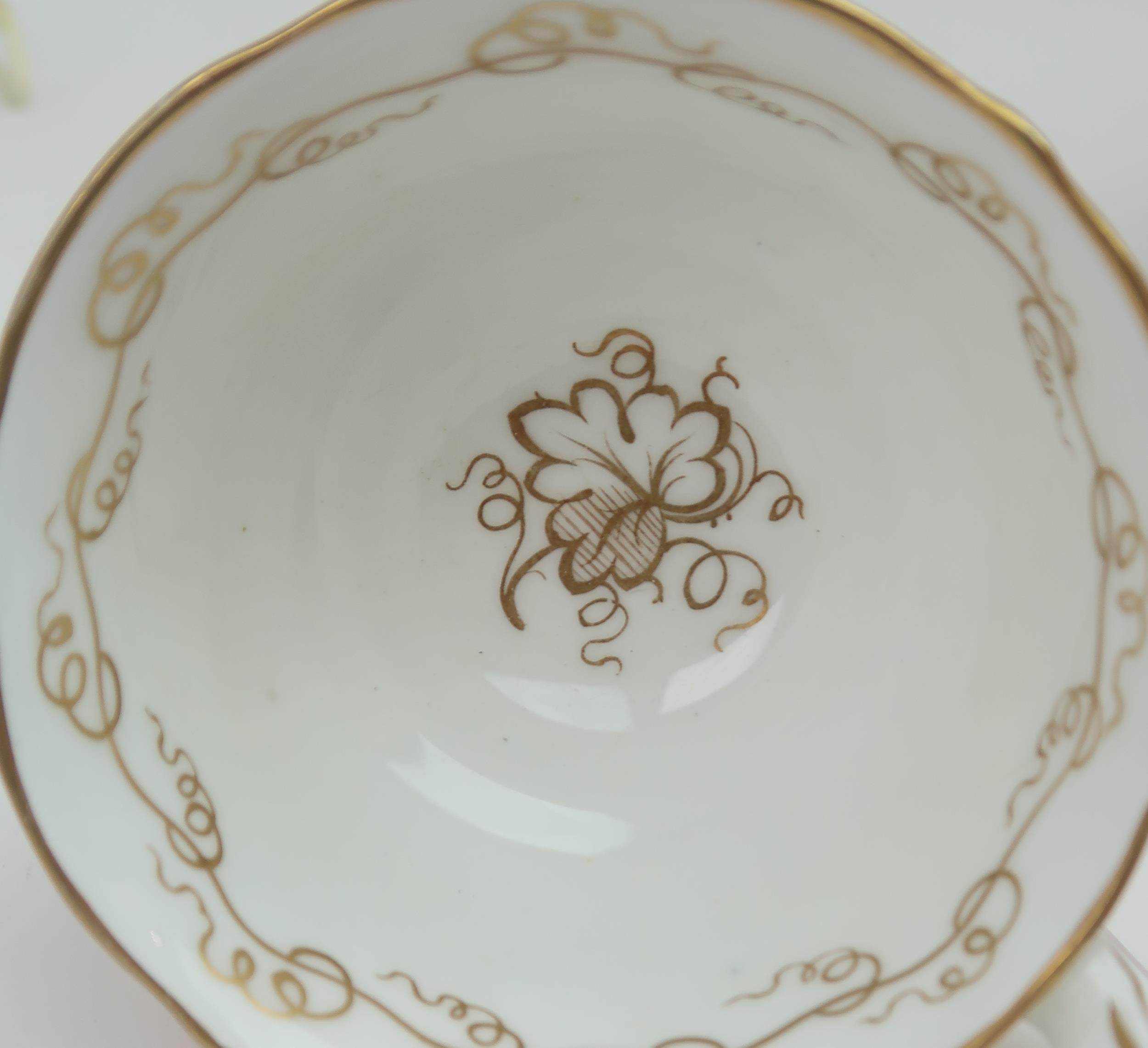 A ROCKINGHAM STYLE TEASET of moulded rococo design, the white ground with gilt vine and grape - Image 7 of 7