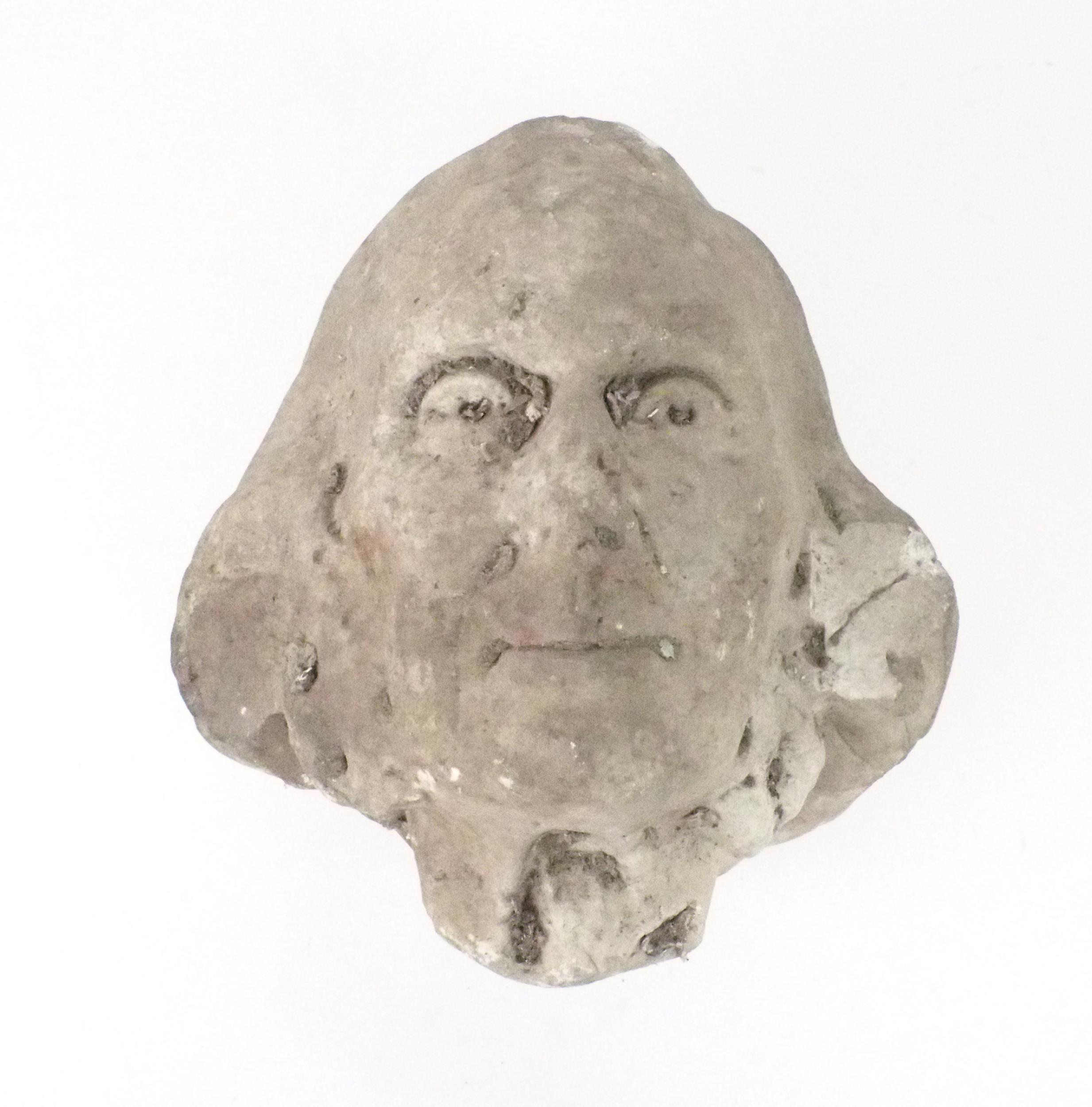 A CARVED COMPOSITE STONE HEAD OF A MAN 28cm high Condition Report:Available upon request