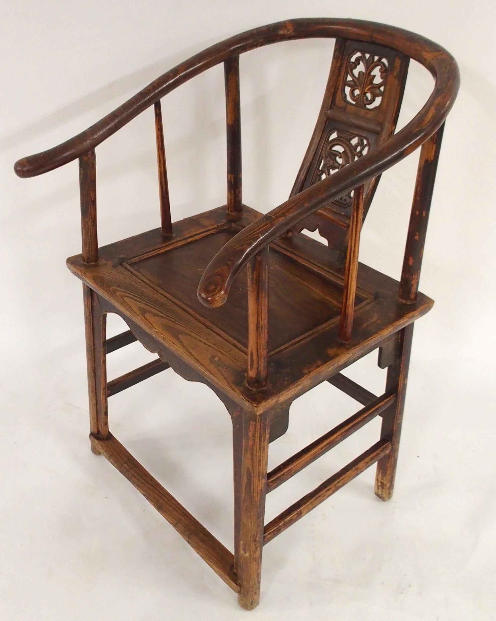 A CHINESE HARDWOOD HORSESHOE SHAPED ARMCHAIR with carved fret work splat on stretchered supports
