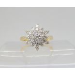A DIAMOND SNOWFLAKE RING mounted throughout in 18ct yellow and white gold, set with estimated approx