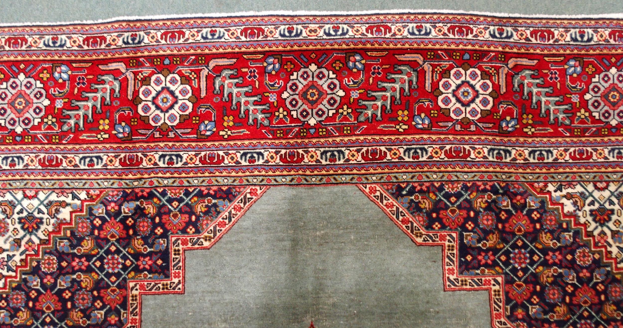 A GREEN GROUND TABRIZ RUG with red geometric central medallion, dark blue and white spandrels and - Image 6 of 7