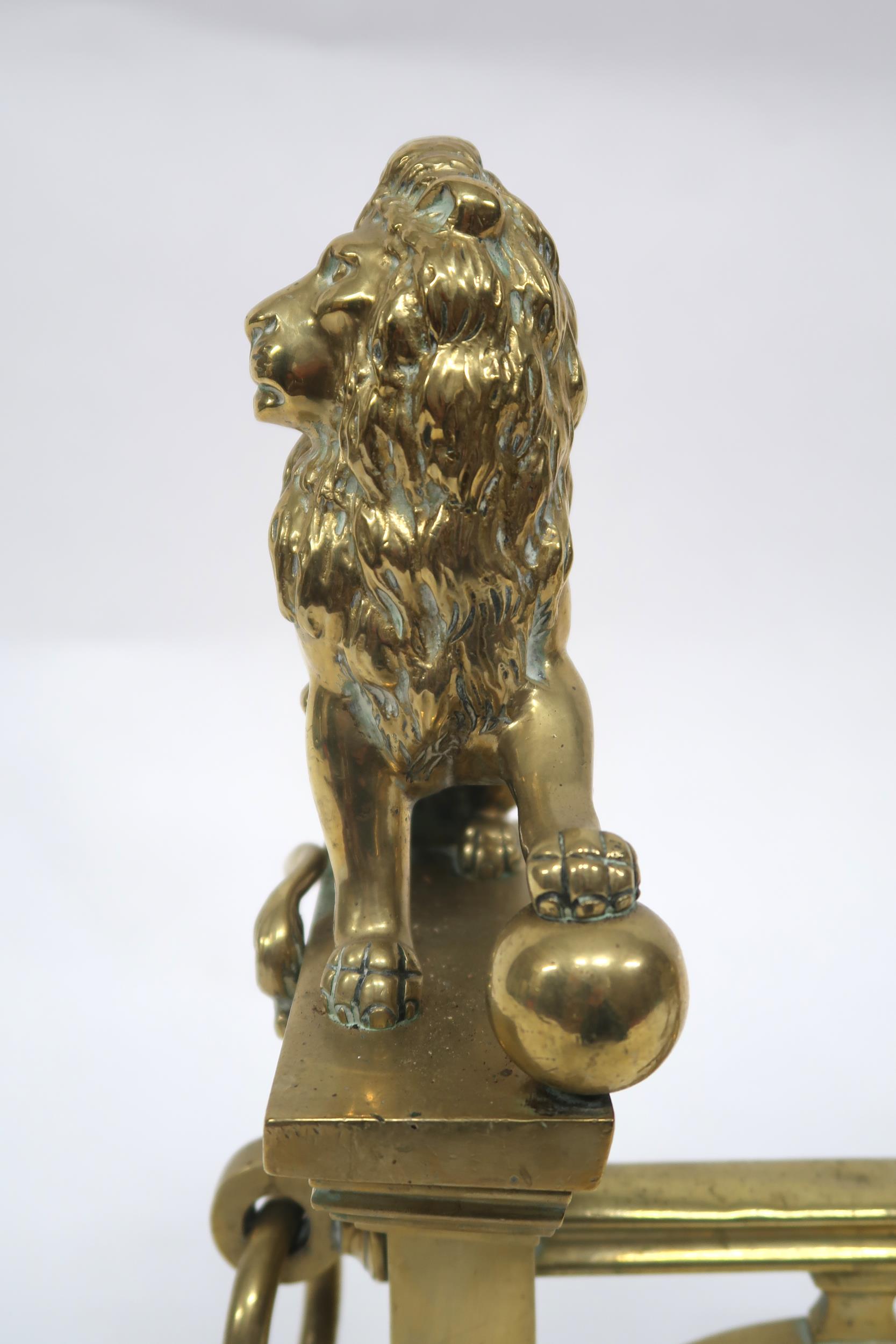 A PAIR OF EARLY 20TH CENTURY CAST BRASS FIRE DOGS mounted with figural lions, 46cm high x 23cm - Image 7 of 7
