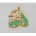 CHINESE GREEN HARDSTONE FISH PENDANT the mount is stamped 14k and set with two carved fish. length