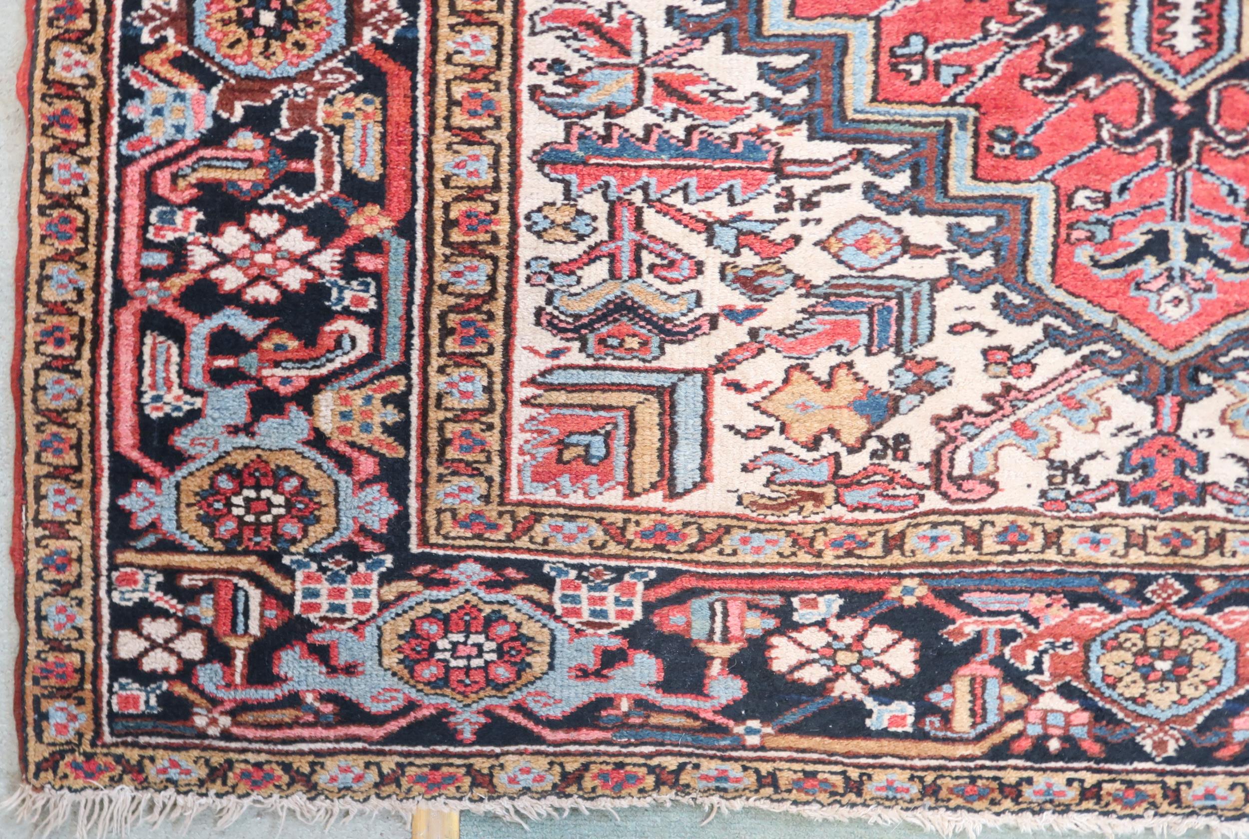 A RED GROUND KAZAK RUG with dark blue geometric central medallion, off white spandrels and geometric - Image 2 of 7