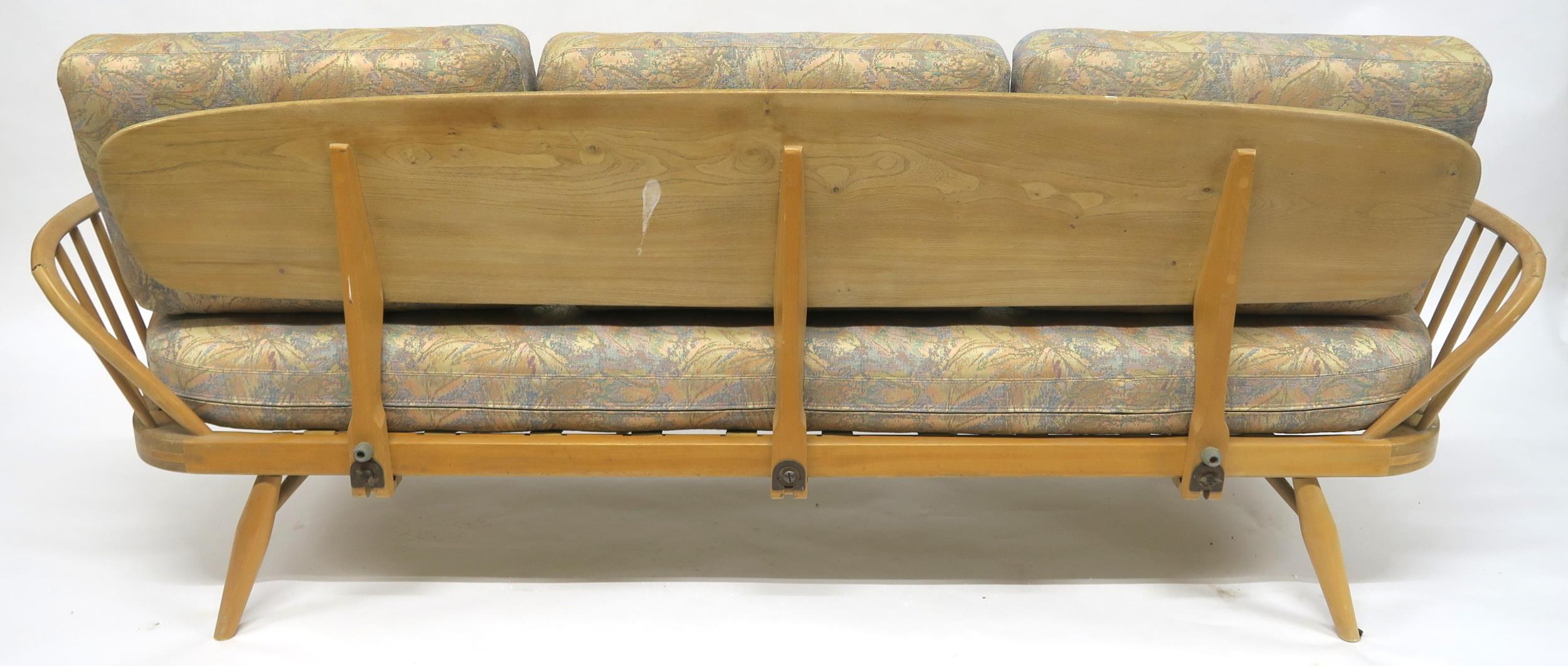 A MID 20TH CENTURY ELM AND BEECH FRAMED ERCOL DAY BED with floral upholstered cushions, 77cm high - Image 11 of 11