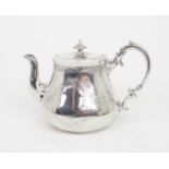 A VICTORIAN SILVER TEAPOT of swollen cylindrical form, the body with engraved floral decoration, the