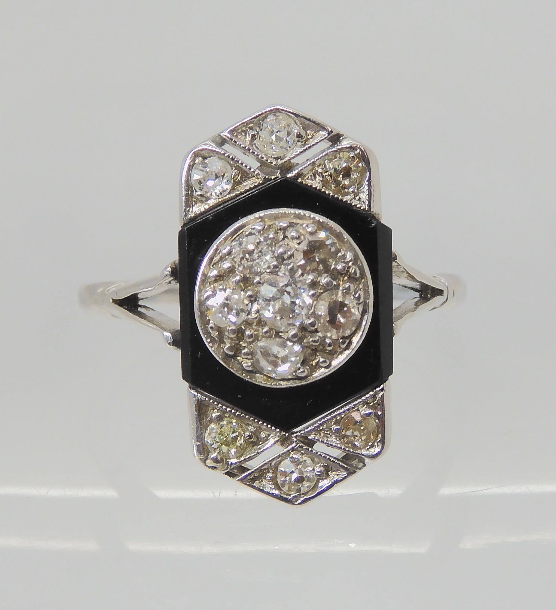 AN OLD CUT DIAMOND AND ONYX RING the white metal mount is set with estimated approx 0.40cts of old