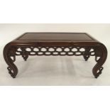 A 20TH CENTURY CHINESE HARDWOOD LOW TABLE with carved fretwork bowed ends and friezes, 41cm high x