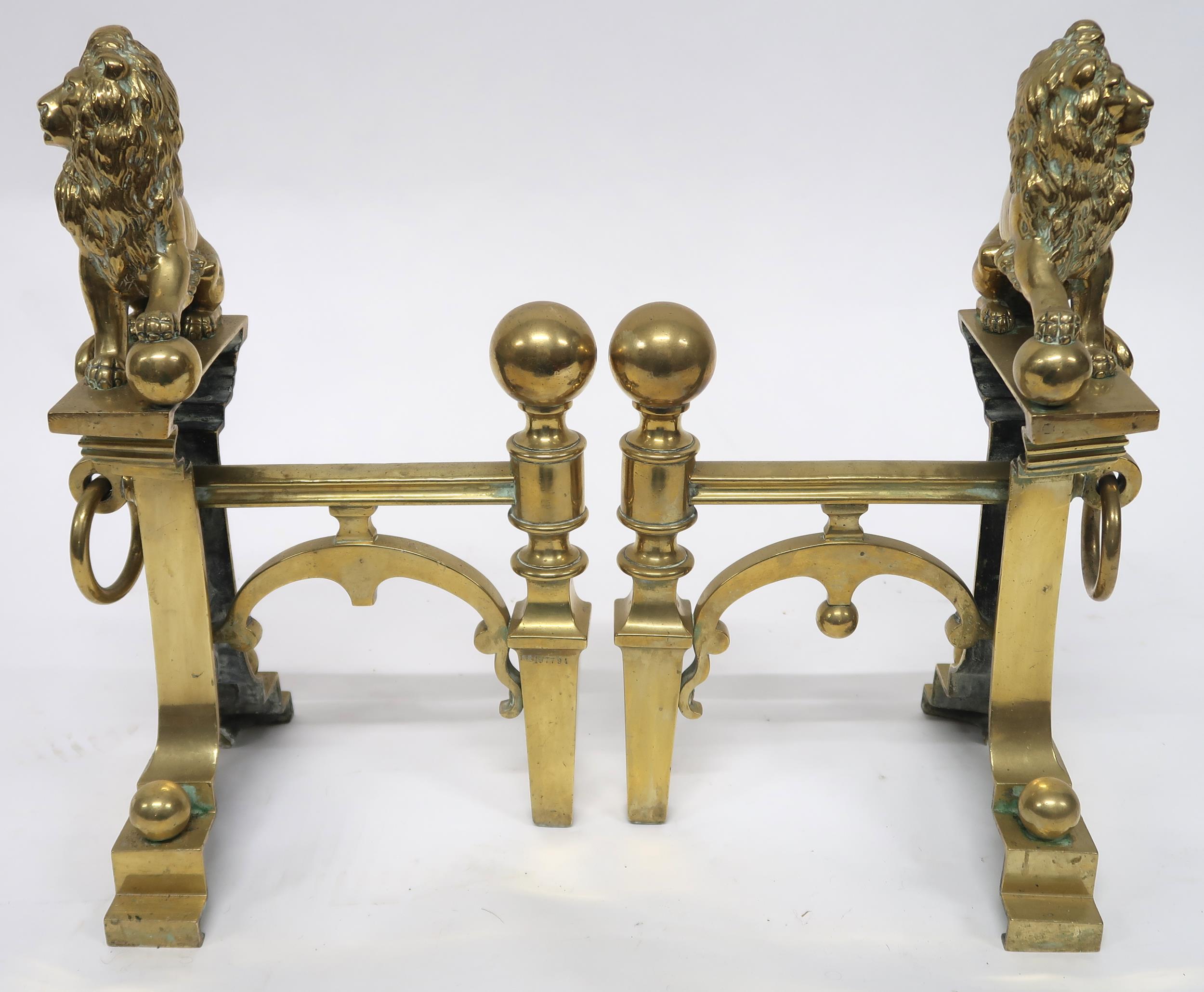 A PAIR OF EARLY 20TH CENTURY CAST BRASS FIRE DOGS mounted with figural lions, 46cm high x 23cm - Image 5 of 7