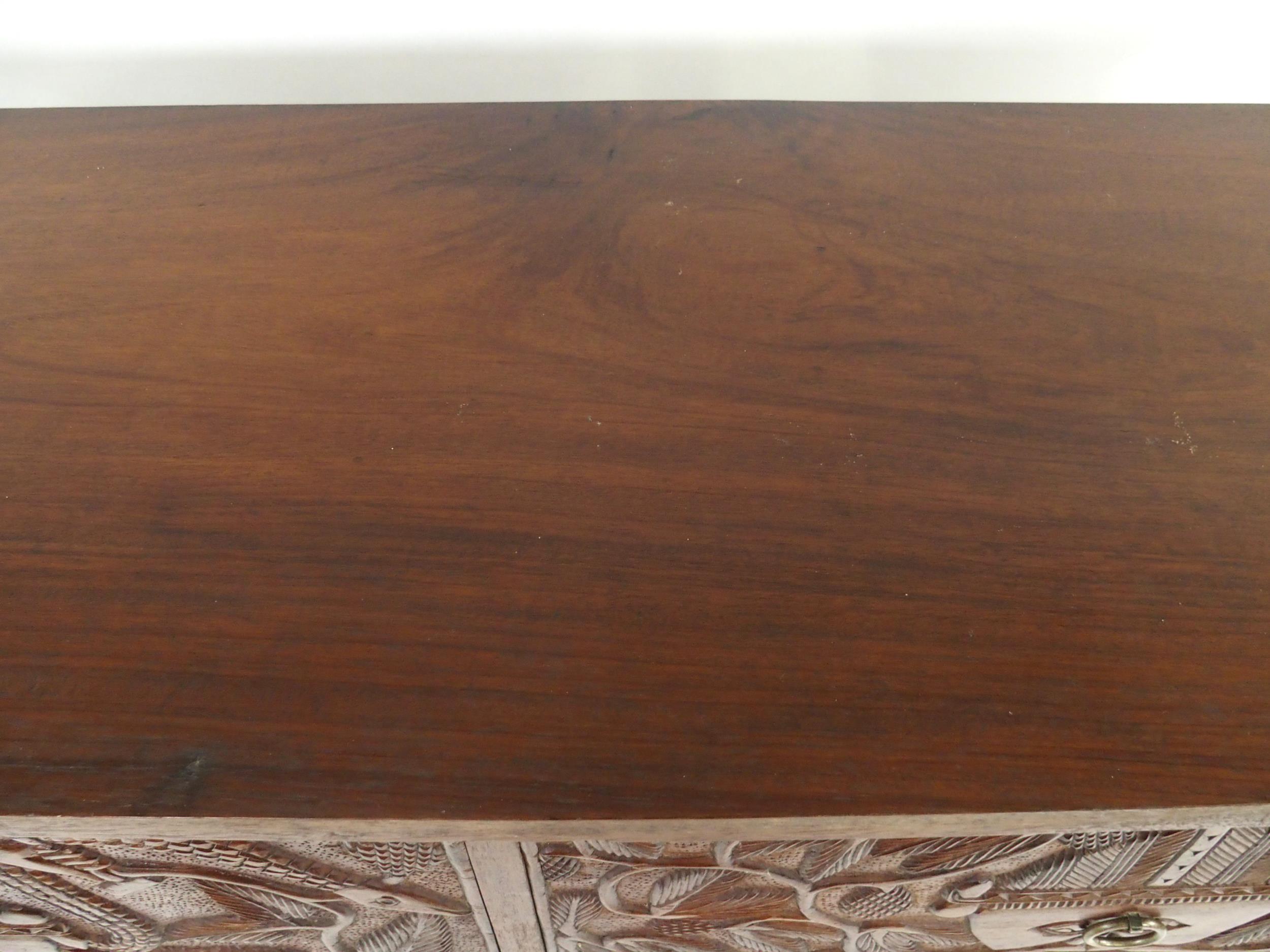 A 20TH CENTURY AFRICAN HARDWOOD TWO OVER TWO CHEST OF DRAWERS  with extensively carved drawer - Image 3 of 7