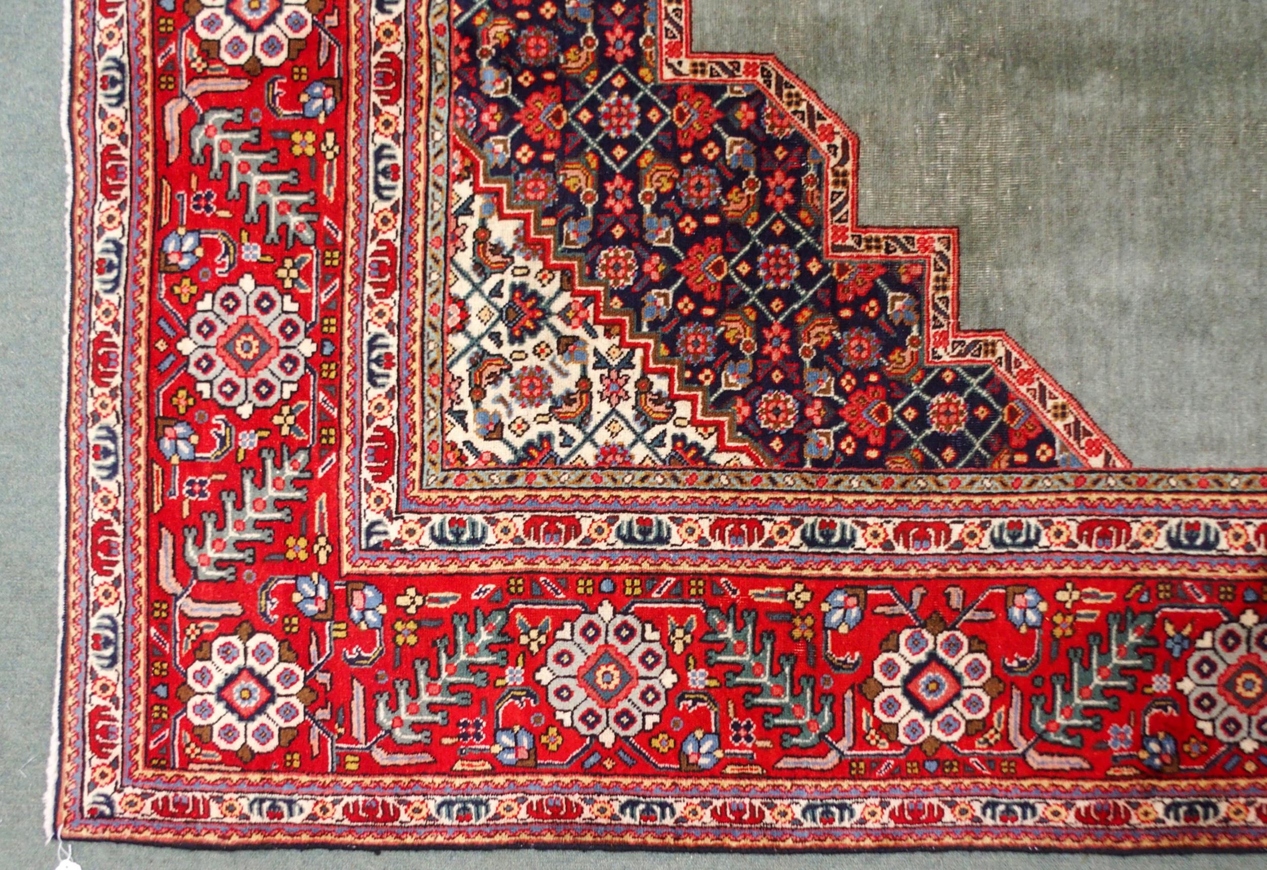 A GREEN GROUND TABRIZ RUG with red geometric central medallion, dark blue and white spandrels and - Image 4 of 7