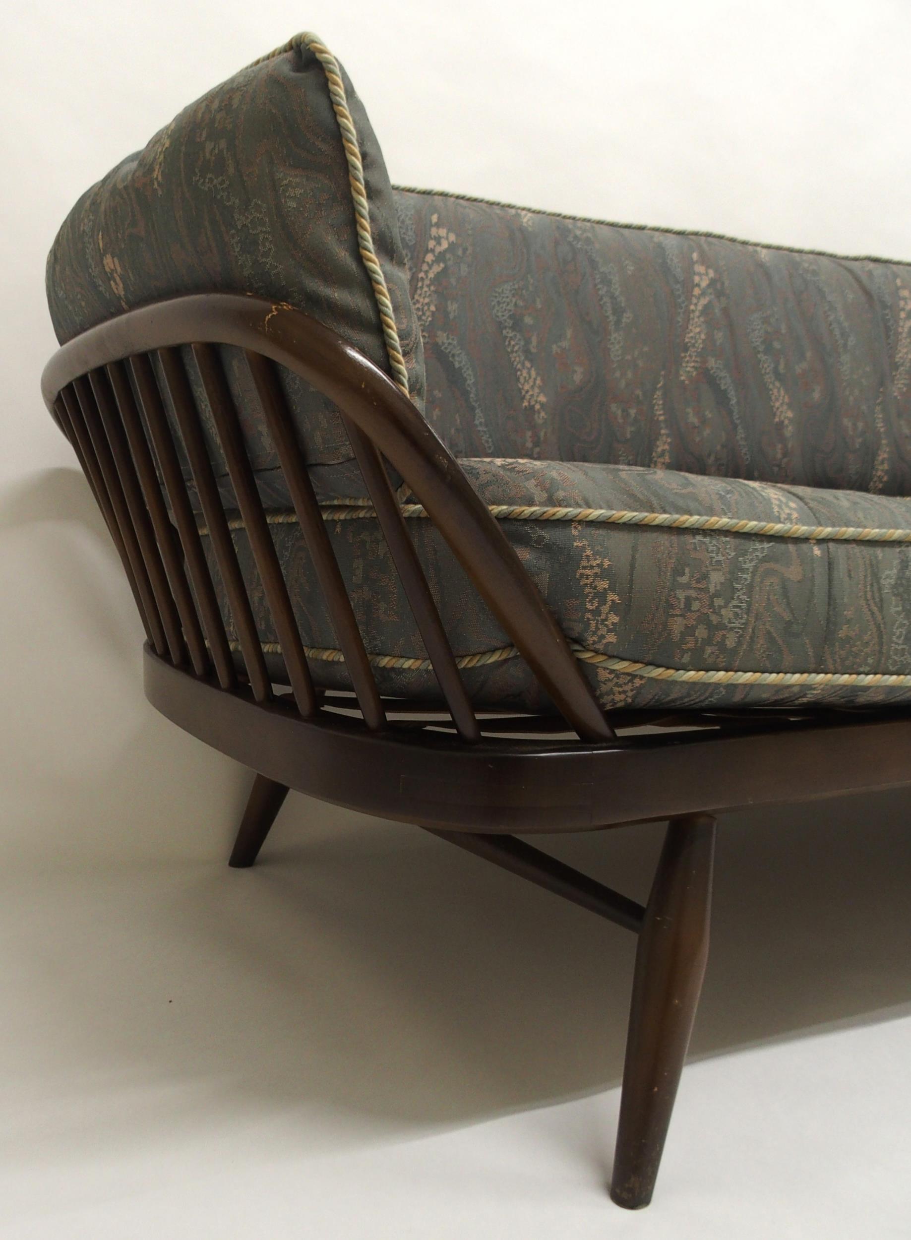 A MID 20TH CENTURY STAINED ELM AND BEECH FRAMED ERCOL DAY BED with blue upholstered cushions, 77cm - Image 3 of 9