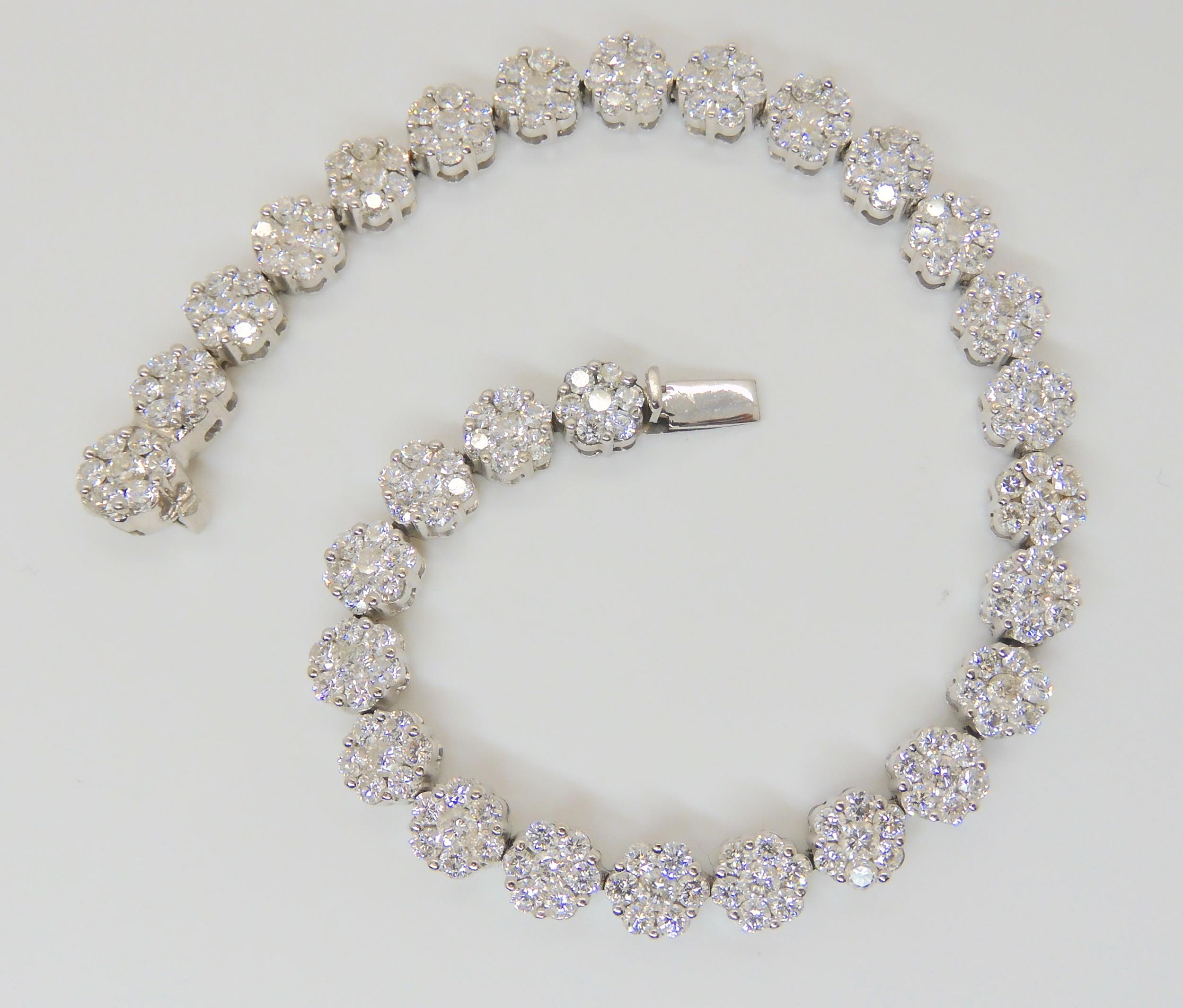 A 14K WHITE GOLD DIAMOND FLOWER BRACELET comprising twenty nine flowers clusters, each comprising - Image 2 of 6