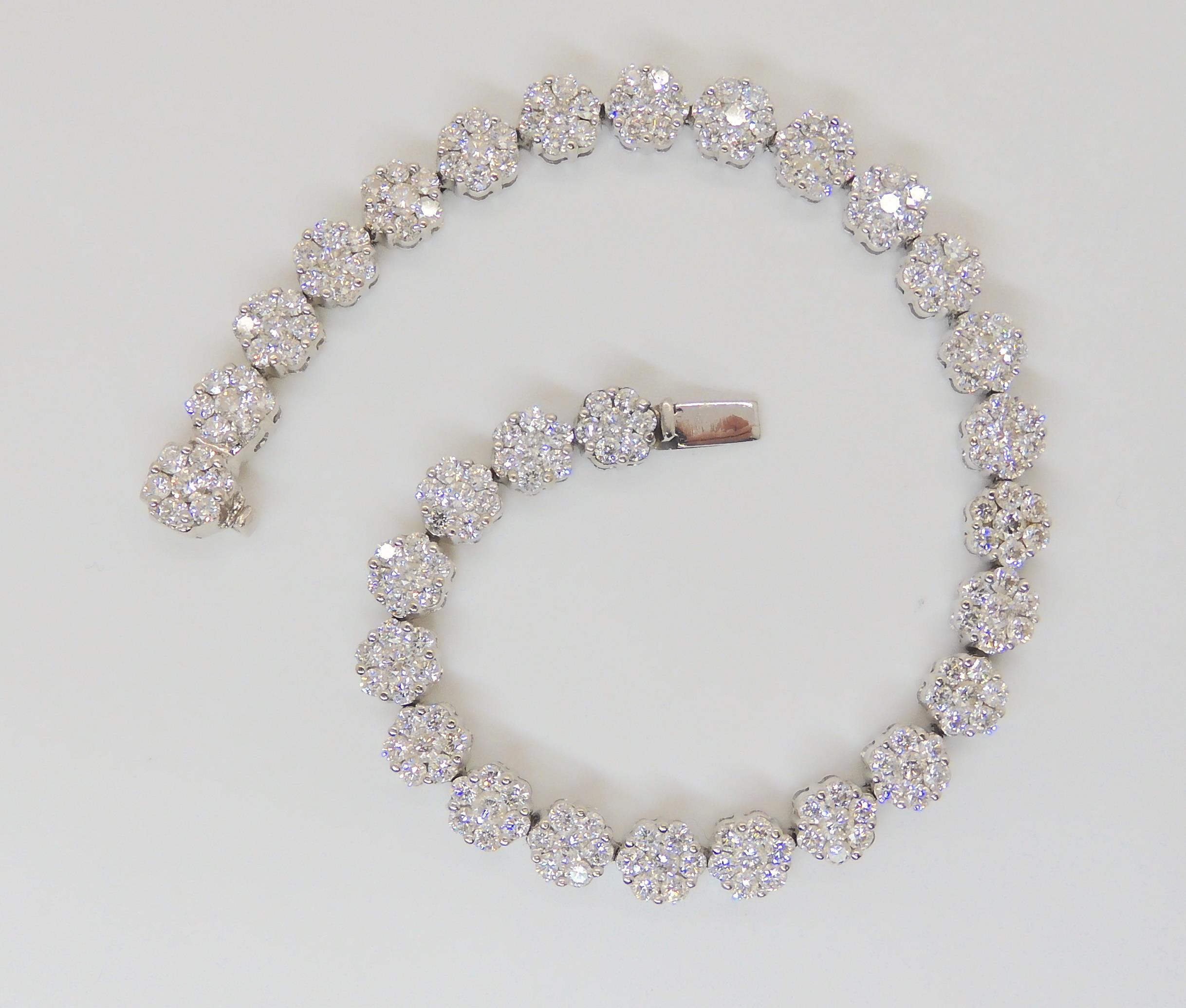 A 14K WHITE GOLD DIAMOND FLOWER BRACELET comprising twenty nine flowers clusters, each comprising - Image 3 of 6