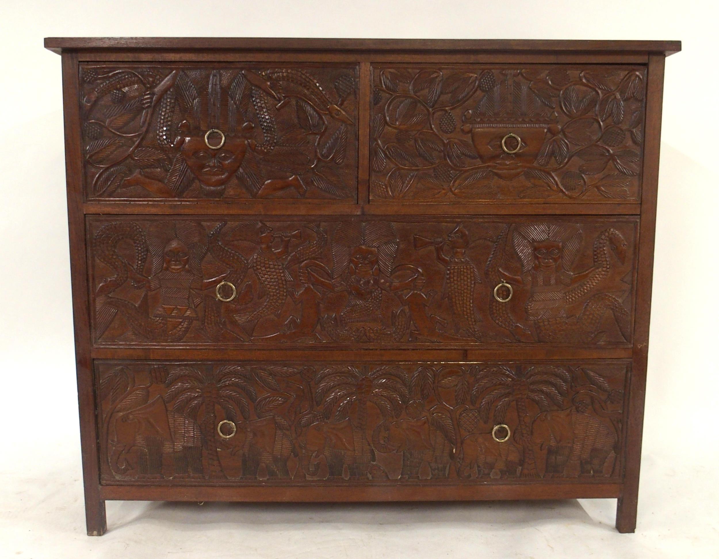 A 20TH CENTURY AFRICAN HARDWOOD TWO OVER TWO CHEST OF DRAWERS  with extensively carved drawer