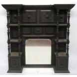A VICTORIAN STAINED OAK BARONIAL STYLE OVERMANTLE MIRROR with shaped bevelled glass mirror flanked