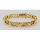 A 15CT GOLD OPAL BRACELET each knot shaped link set with an opal (four missing) length 18.2cm,