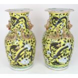 A PAIR OF CHINESE YELLOW GROUND VASES  Each applied with gilt dragons and shishi, amongst