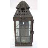 AN EARLY 20TH CENTURY ARTS & CRAFTS CANDLE LANTERN with swing handle over pierced decoration over