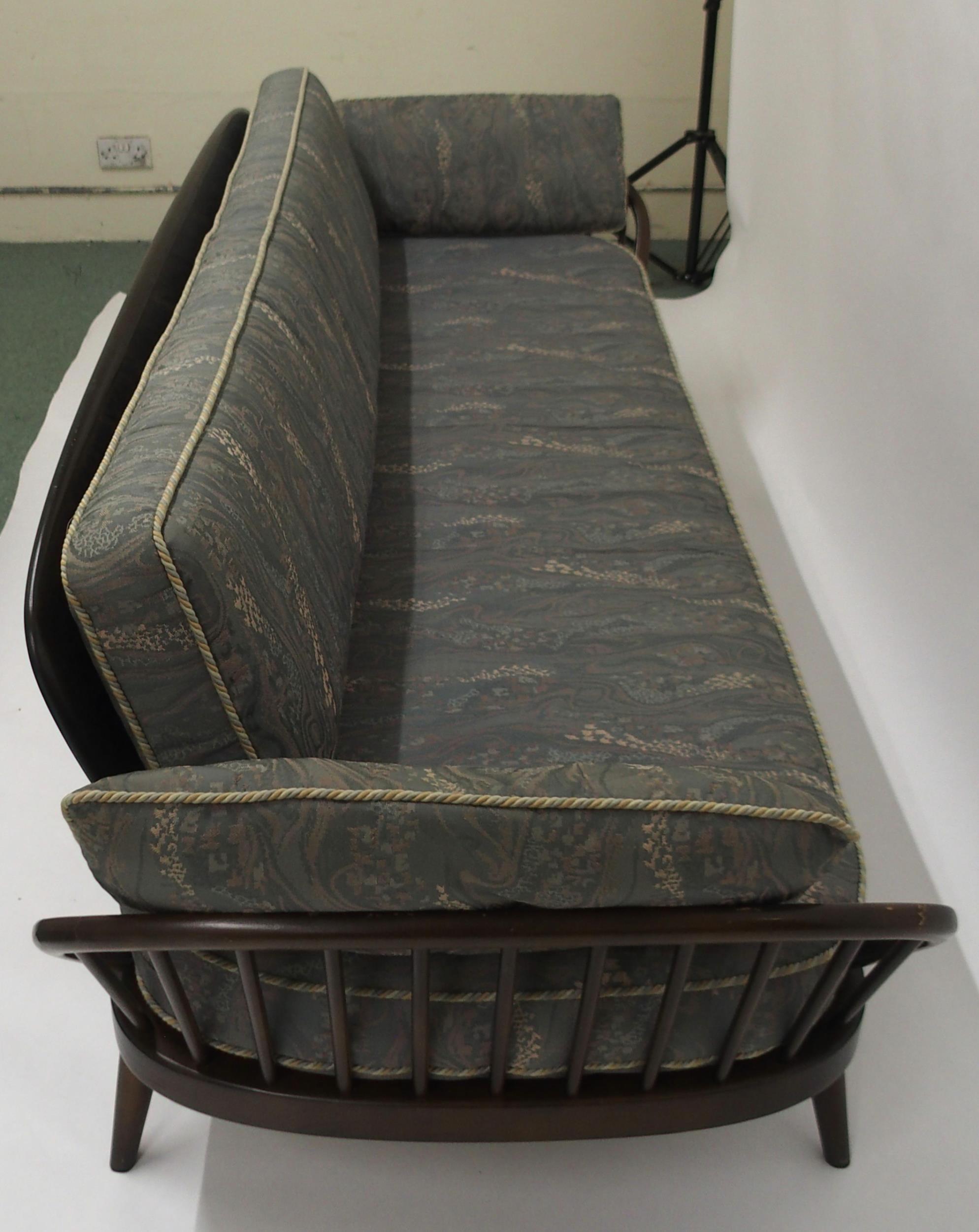A MID 20TH CENTURY STAINED ELM AND BEECH FRAMED ERCOL DAY BED with blue upholstered cushions, 77cm - Image 9 of 9