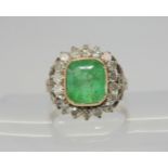 AN EMERALD AND DIAMOND RING set throughout in yellow and white metal with diamond set fleur de lys