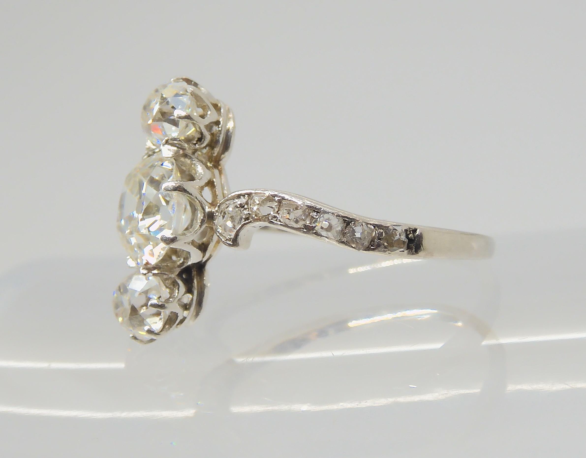 A VINTAGE THREE STONE DIAMOND RING the central old cut is estimated approximately at 0.95cts, with - Image 7 of 12