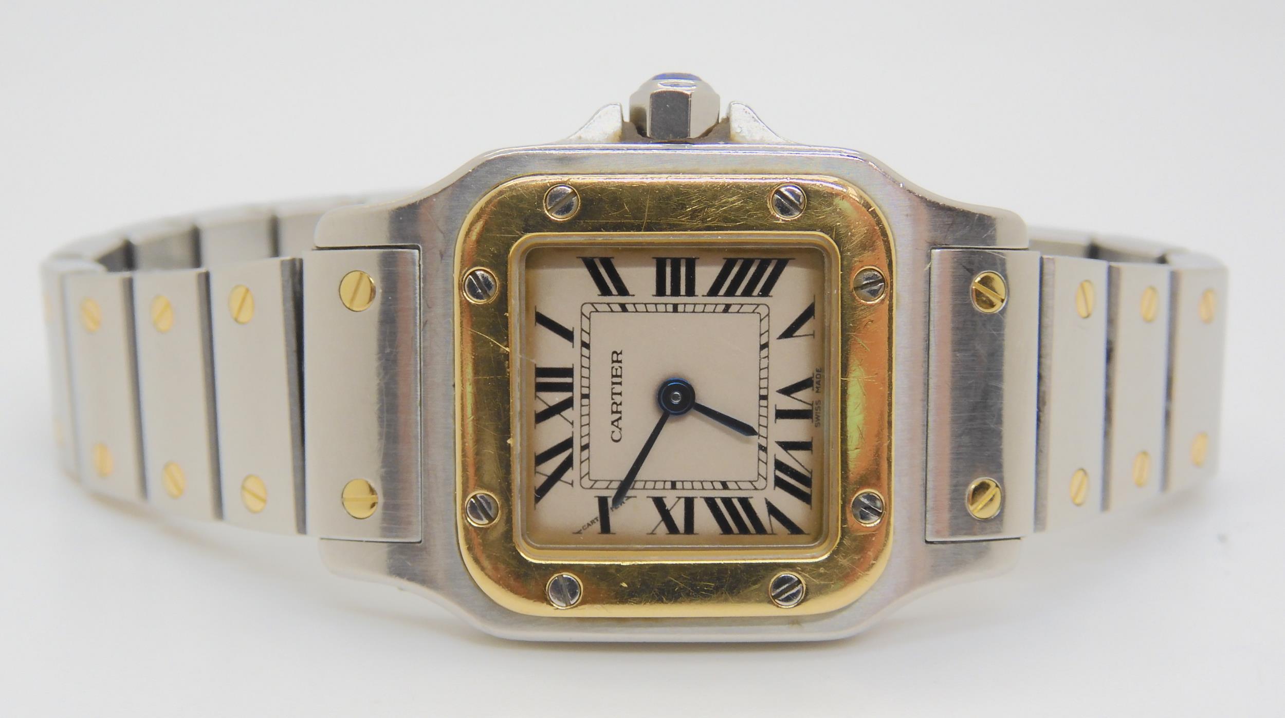 A LADIES CARTIER WATCH in gold and stainless steel, with cream dial, black Roman numerals and