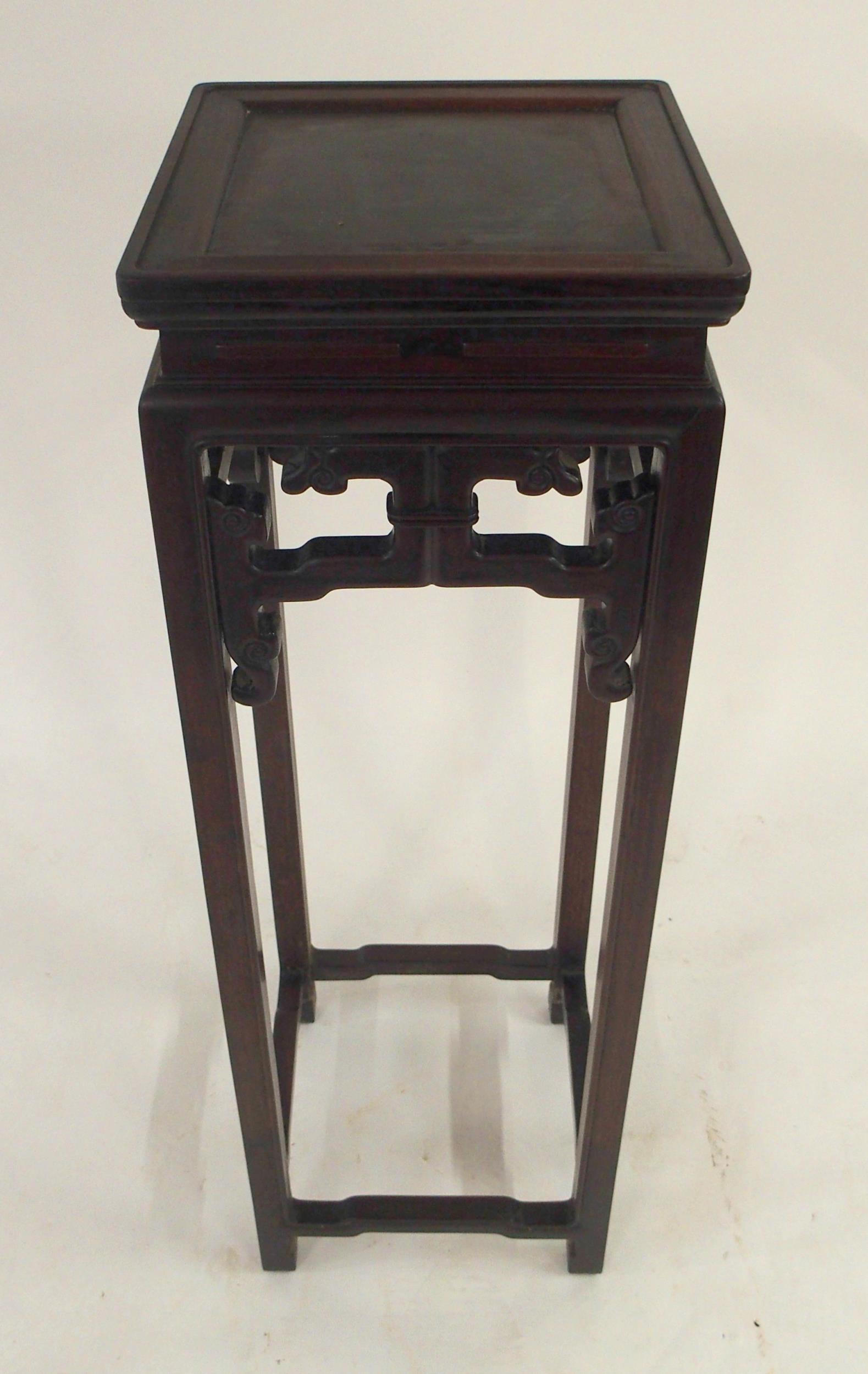 A 20TH CENTURY CHINESE HARDWOOD PLANT PEDESTAL with square top over carved fretwork friezes on