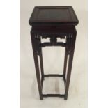 A 20TH CENTURY CHINESE HARDWOOD PLANT PEDESTAL with square top over carved fretwork friezes on